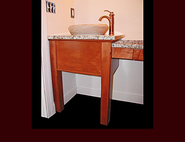 Stained maple vanity with flat skirting and posts.