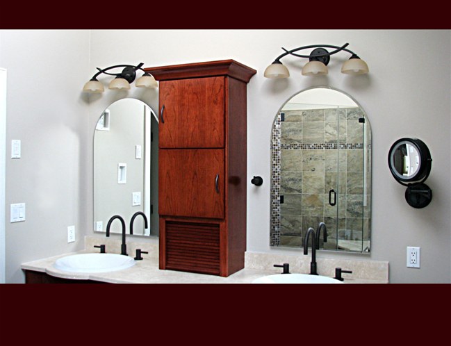 Cherry Bath Cabinet over vanity. Slab door style with tambour storage. Cove crown moulding.