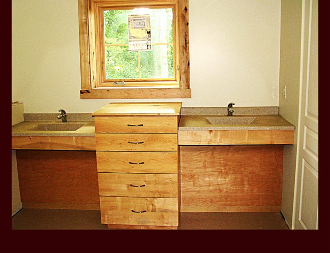 Hickory Master Bath Double Sink cabinetry with center drawer base. ADA Handicap Accessible sinks. Modern slab design.