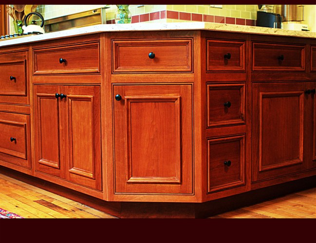 Cherry Kitchen Cabinetry. Flat Panel doors/drawers with applied molding. Inset doors with beaded face frame. Full extension, soft-close drawer guides.