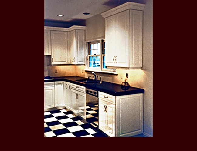 White Lacquer Maple Kitchen Cabinets. Raised Panel door style. Decorative end panels. Crown Moulding. 9' ceiling height.